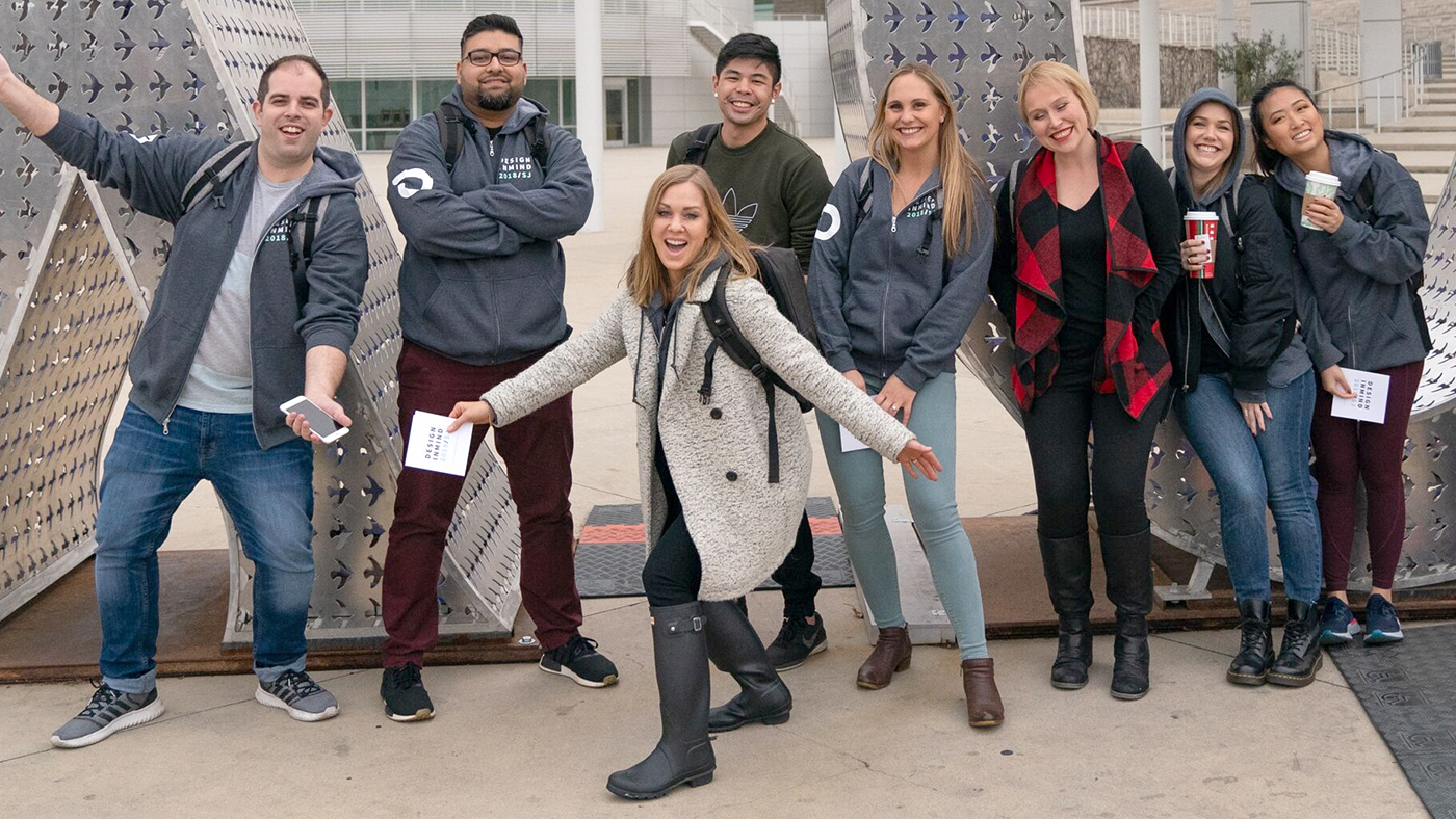fun team photo between XO sculpture