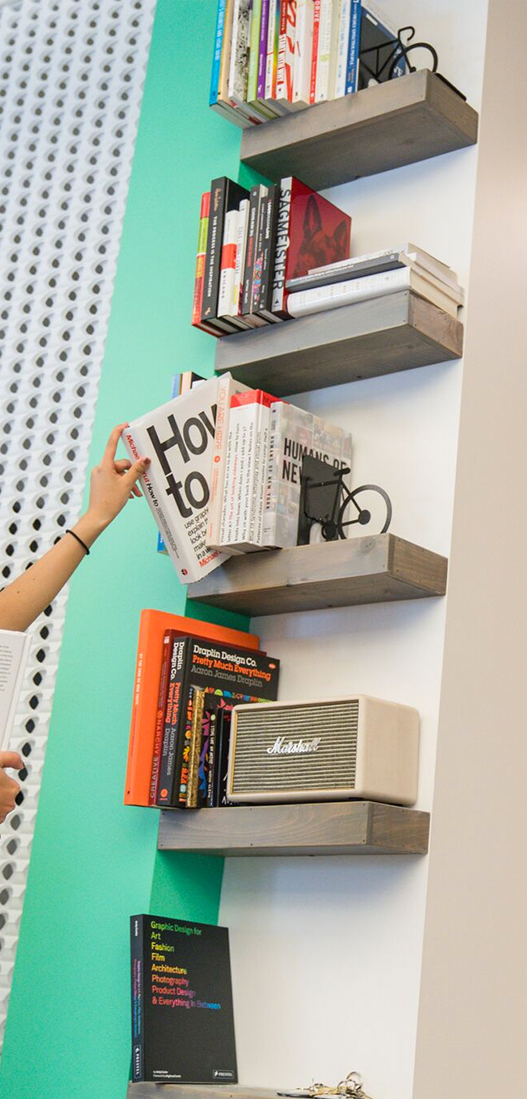 picking up a book from a bookshelf