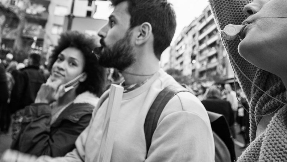 protester blowing a whistle in black and white