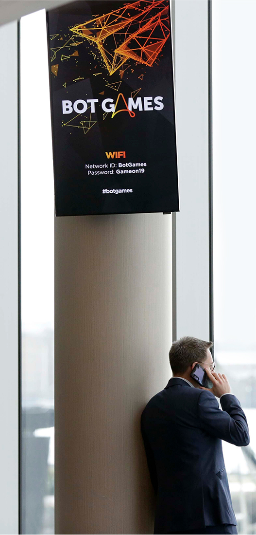 Botgames wifi info on screen with businessman looking outside window