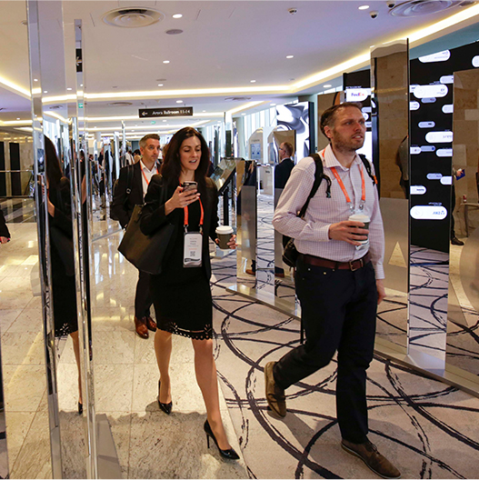 People walking through lobby with reflective panels