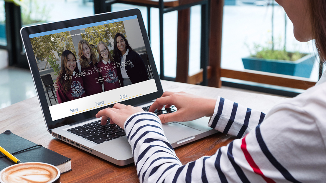 NotreDame-Girl-Using-Site Girl using notre dame site on laptop web design
