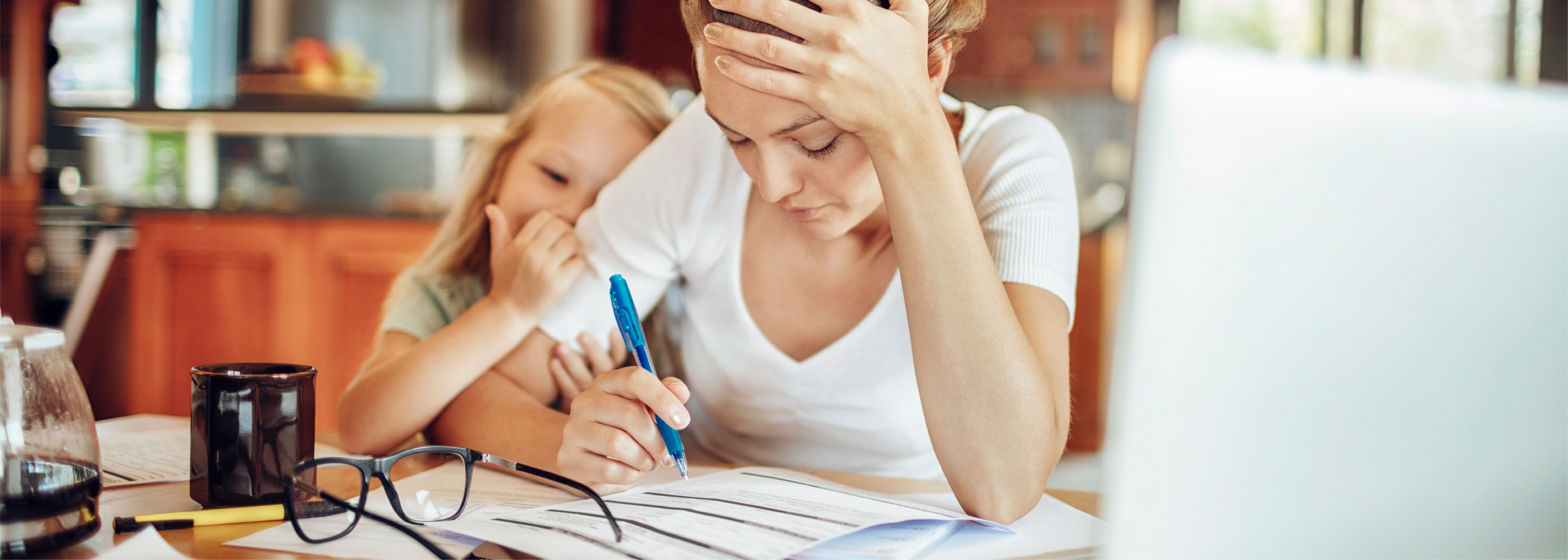 Overworked mom signing forms with kid