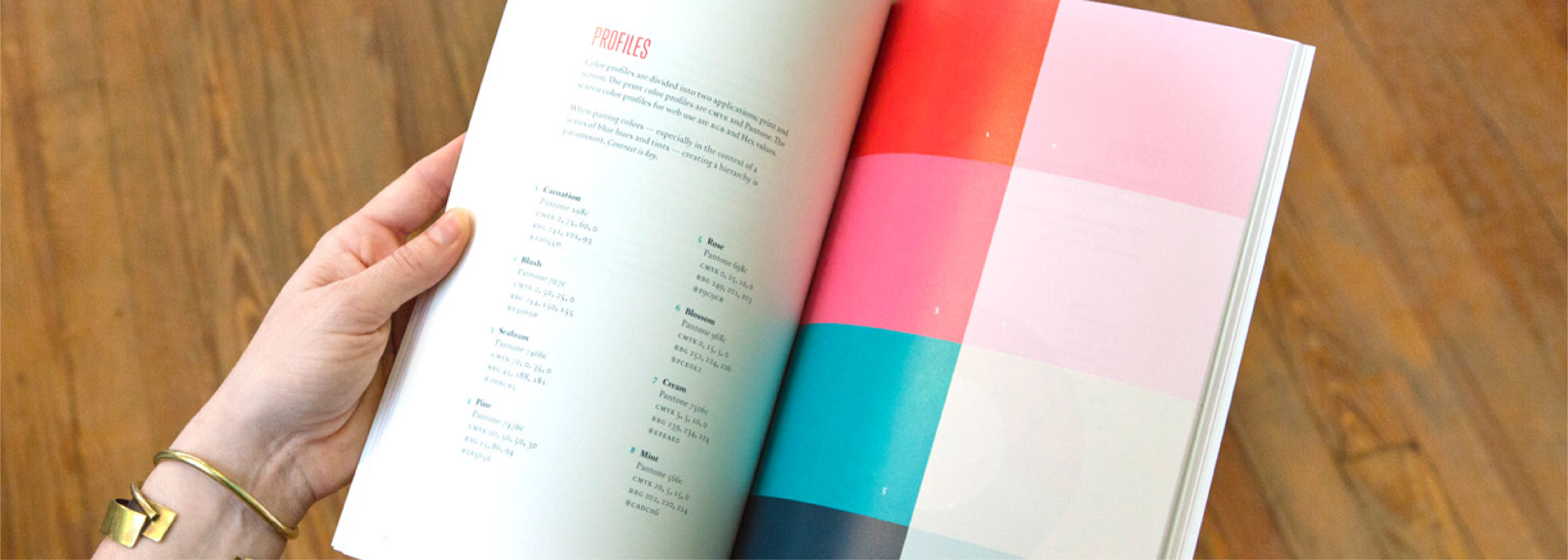 Hand flipping through the pages of brand guidelines marketing design