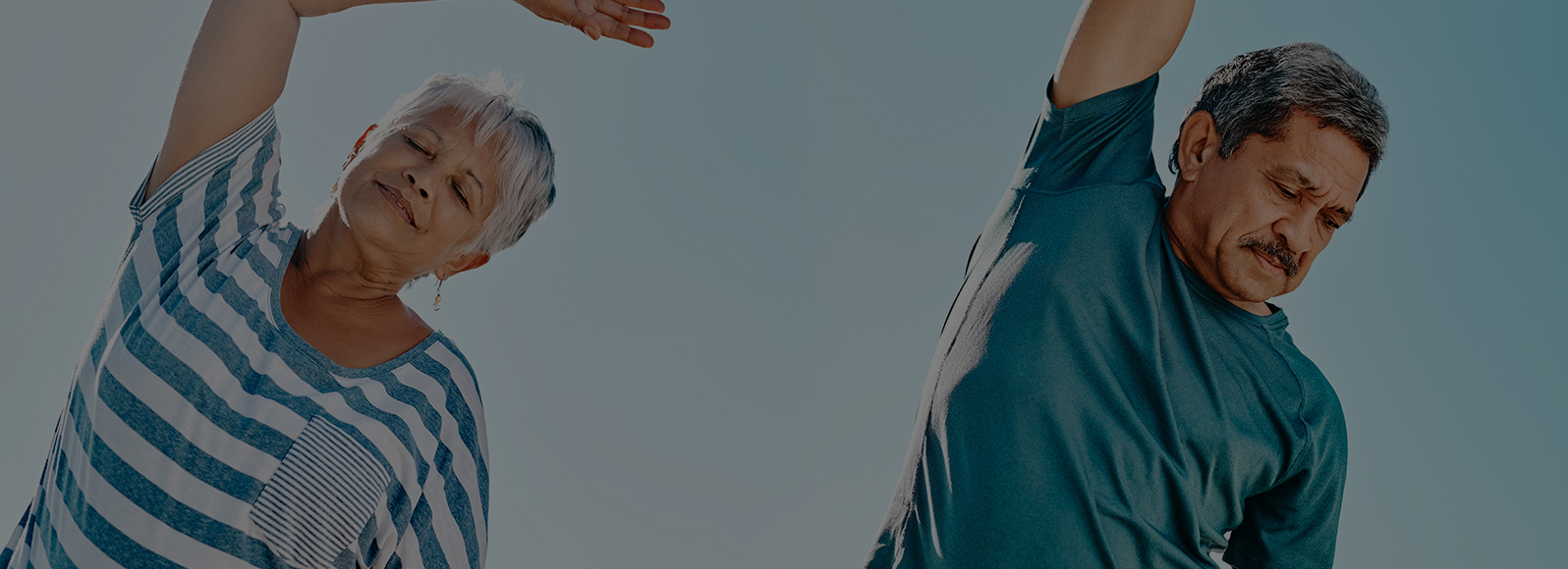 two elderly people stretching