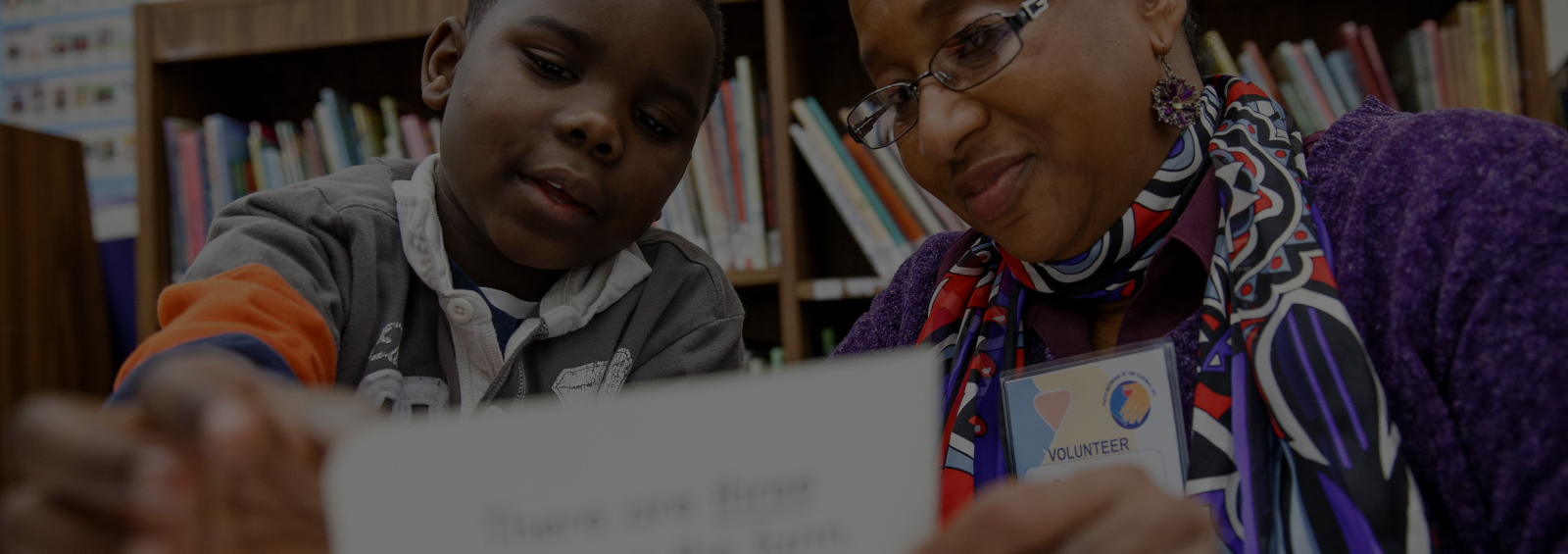Children-Rising-Header Teacher helping student